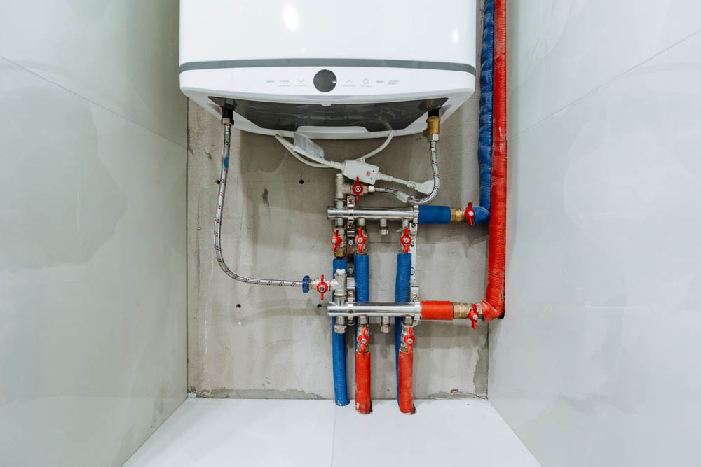 close-up of a new water heater with visible pipes and connections